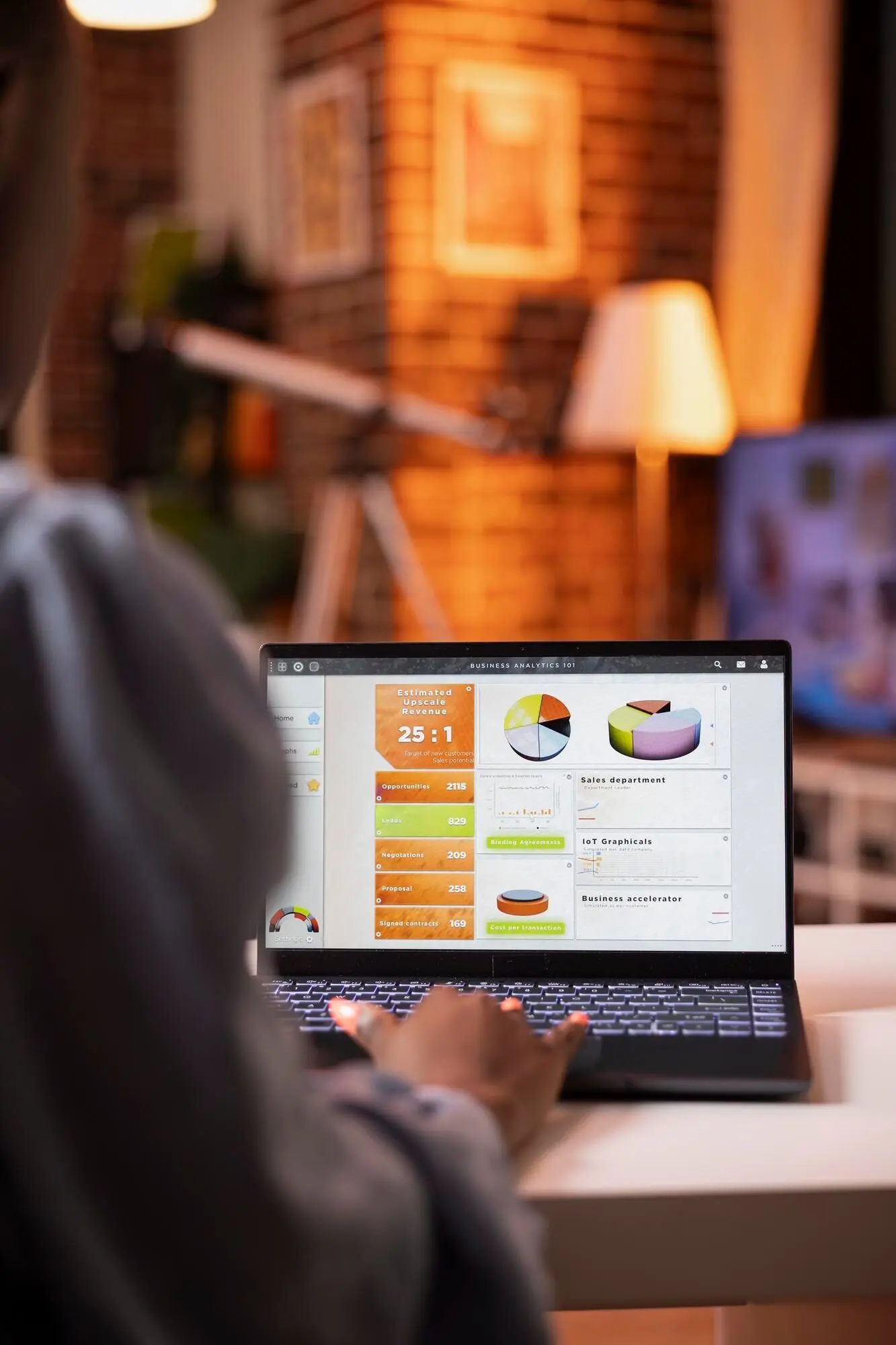 Close-up of an African American woman typing on a laptop.